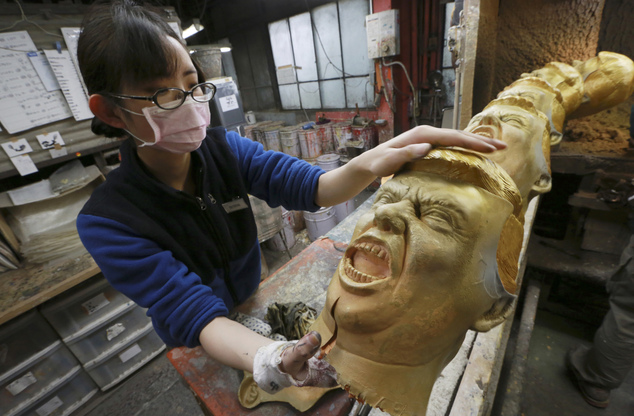 A worker prepare to color rubber masks depicting President-elect Donald Trump at Ogawa Studio in Saitama, north of Tokyo, Tuesday, Nov. 15, 2016. The masks emphasize Trump’s characteristic hair and facial expression. They are first spray painted to add natural tan to the skin and yellowing to the hair. Then an employee hand paints details such as blue eyes for a life-like resemblance. (AP Photo/Eugene Hoshiko)